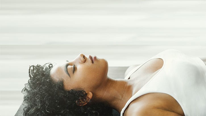 woman breathing on yoga mat