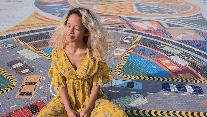 young woman smiling on a mosaic